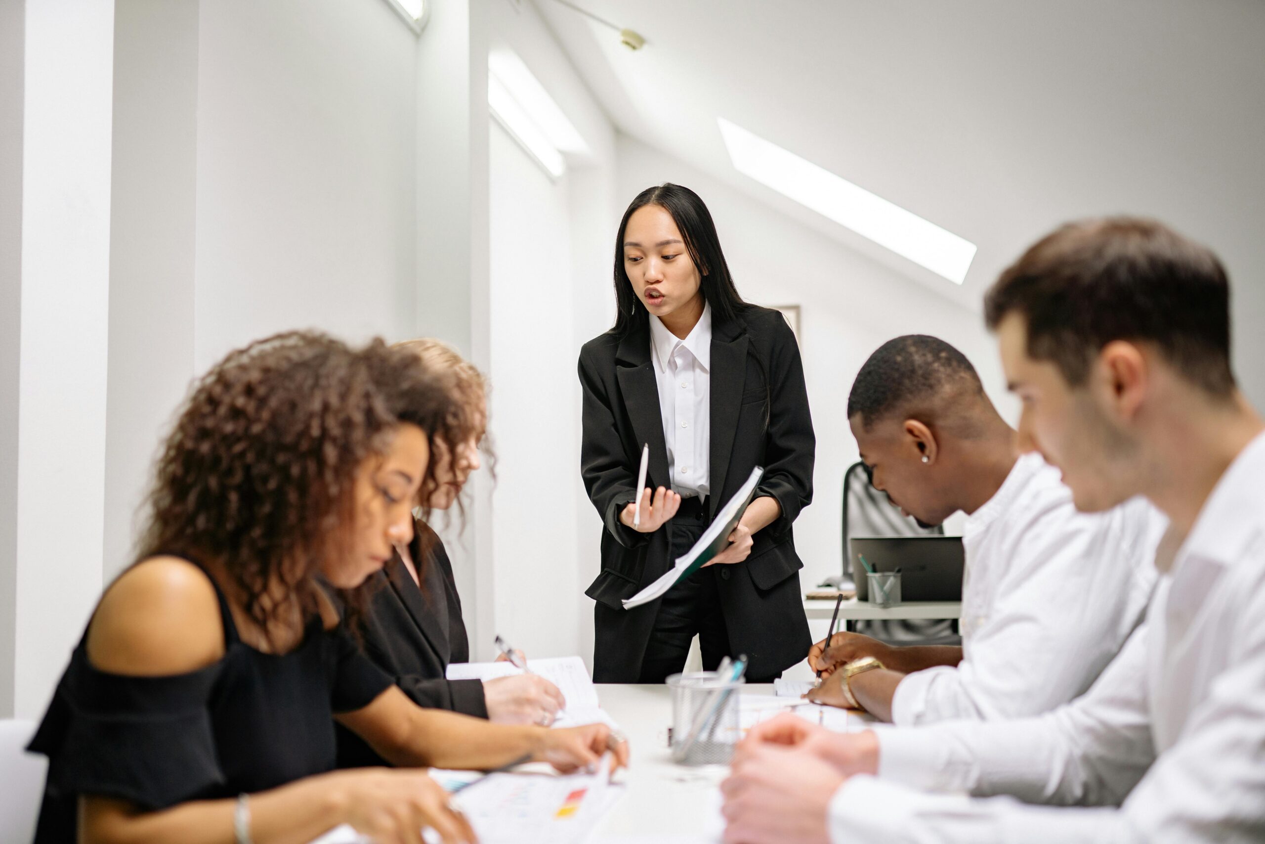 A group of people in the middle of a meeting.